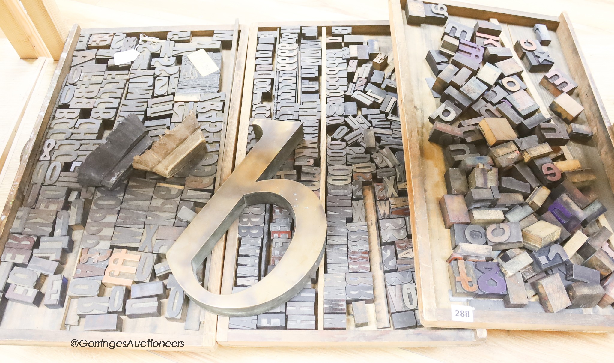 Three trays of printing blocks and letters two other patterned printing blocks and a large brass model of the letter b